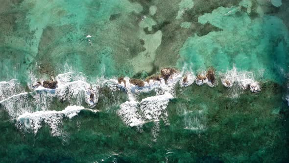 Aerial View Of Ocean Waves Crashing On Rocky Coast Of The Bahamas.
