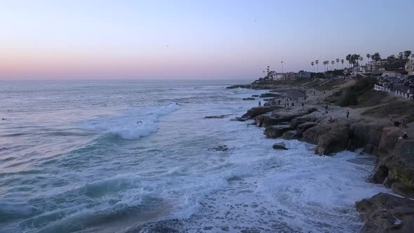 slow motion along the coastline people on the cliff Wonderful aerial view panorama curve flight dron