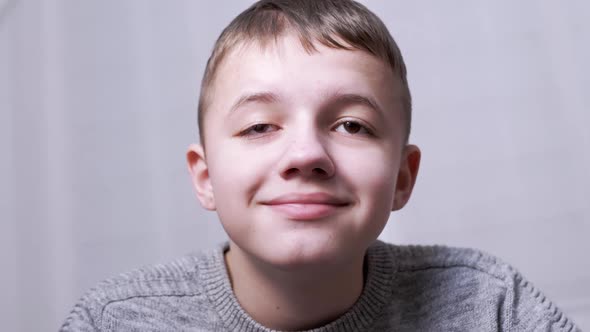 Portrait of Smiling Happy Laughing Boy Looking at Camera