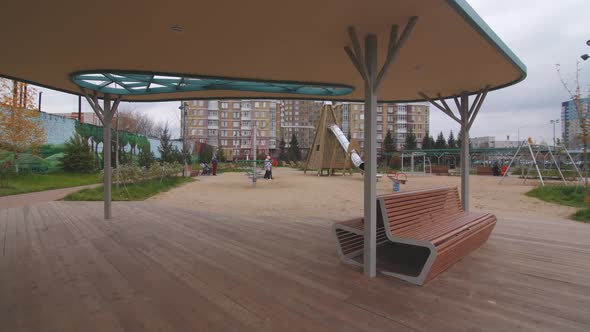 Arbor with Benches Near Playground in Dwelling District