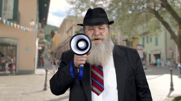 Senior Man Announcing a Message Through Megaphone