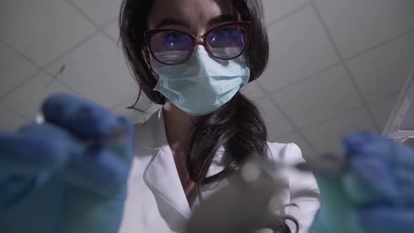 Extreme Close-up Face of Beautiful Brunette Caucasian Woman in Eyeglasses and Protective Mask Using