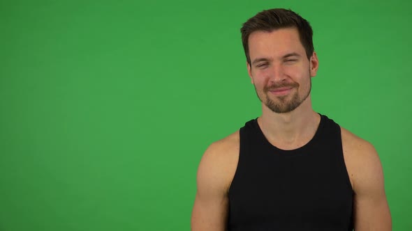 A Young Handsome Athlete Smiles at the Camera - Green Screen Studio