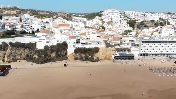 Panoramic of Albufeira mediterranean shoreline in Algarve, Portugal - Pan Aerial shot