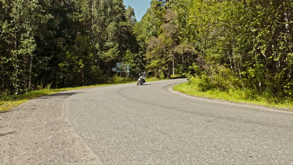 A Brutal Man Motorcyclist Driving Around the Corner