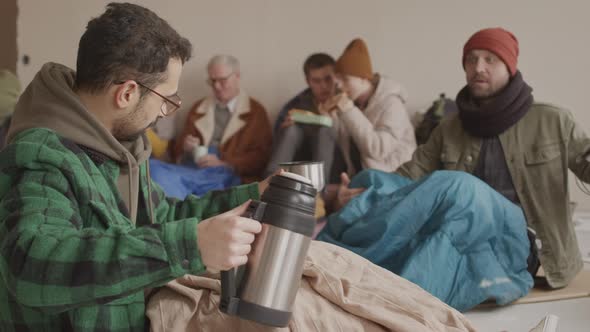 Refugees Sharing Food and Water Supplies with Each Other