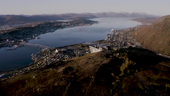 Aerial top down shot Of Tromso view From Fjellheisen viewpoint during sunlight in autumn.River,citys