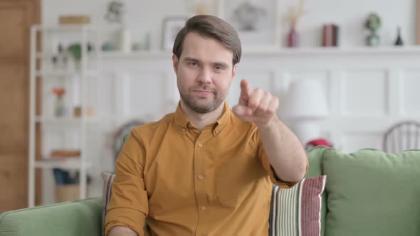 Portrait of Young Man Pointing towards Camera