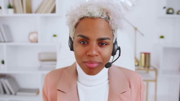 Successful Young African American Woman Online Teacher with Headset Camera View