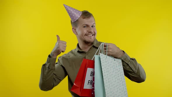 Man Raising Shopping Bags, Dancing, Celebrating, Enjoying Discounts on Black Friday Sale Holiday