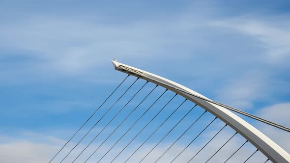 Time lapse of Samuel Beckett Bridge in Dublin City on sunny day with clouds in the sky in Ireland.