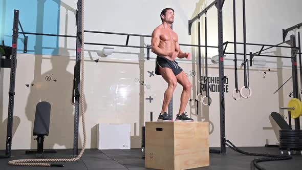 Slowmotion Full Shot of a Fit Young Caucasian Sportsman Training Alone Doing Box Jump Exercise in