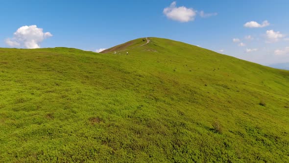 Aerial flight over green hill mountains. FPV Dynamic drone shot