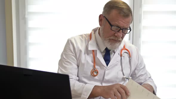 Online Doctor, An Experienced Doctor Consults a Patient Using the Laptop, Covid-19 Epidemic