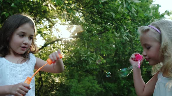 Slow Motion Footage of Beautiful Young Woman Blowing Soap Bubbles