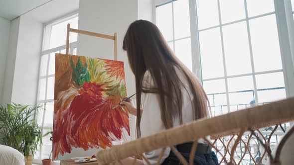 Long Haired Lady at Work Upon Wonderful Painting of Flowers