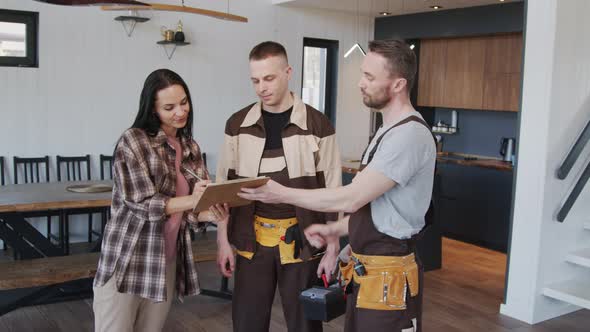 Woman and Handymen Posing in House