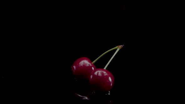 Cherry Slow Motion Closeup Falling in Water with Splash Droplets