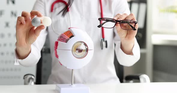 Ophthalmologist Holds Glasses and Contact Lenses in Hands Closeup