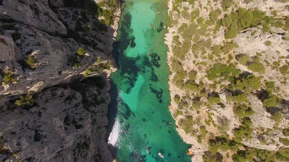 Aerial travel drone view of clear green water, cliffs of Cassis, Mediterranean Sea, Southern France.