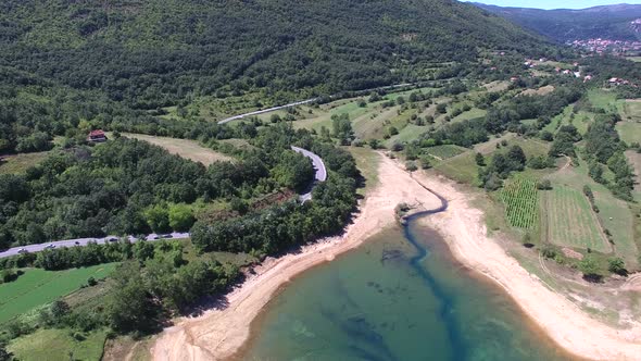 Flying above forested shore of artificial lake Peruca, Croatia