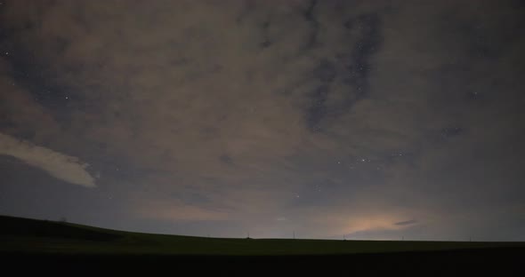 Beautiful Timelapse Of Clouds And Stars At Night - low angle shot