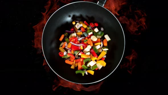 Super Slow Motion Shot of Throwing Vegetables on Wok Pan and Fire Blast at 1000Fps