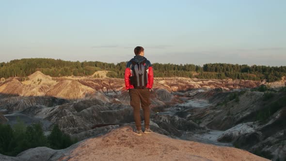 A tourist standing on the edge of a cliff