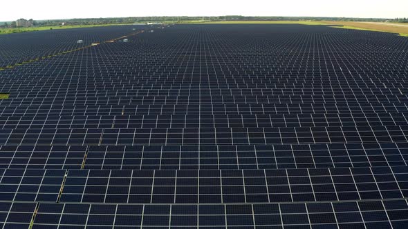 Top view of the power plant with solar panels and the aerodrome. Beautiful green fields.