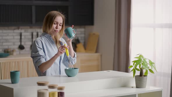 Attractive Girl Dancing in the Kitchen in the Early Morning