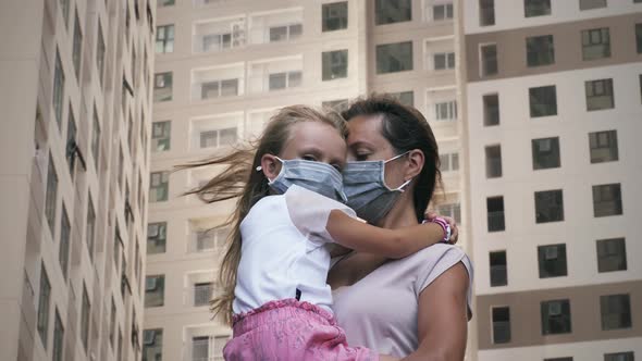 Masked mother and baby. Coronavirus virus in a metropolis