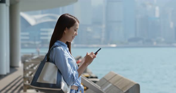Woman check on smart phone in city