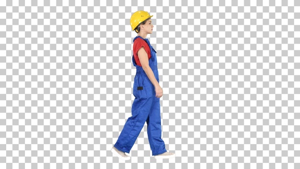 Young woman construction worker in yellow hardhat walking