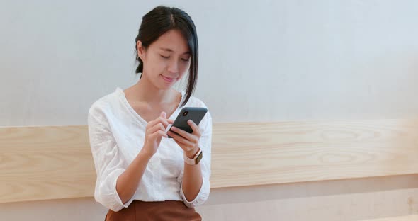 Woman use of smart phone inside coffee shop