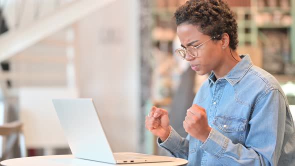 Loss, African Woman Reacting To Failure on Laptop at Cafe 