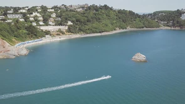 A boat cruising on the water in a beautiful Bay.