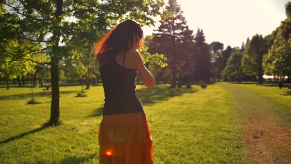 Beautiful Redhead Girl with Long Hair Enjoying Music.