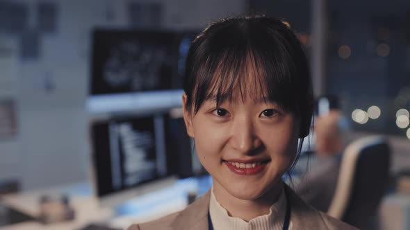 Asian Woman Posing in Office at Night