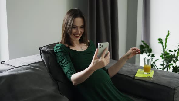 Pregnant Woman Video Chatting on Mobile Phone at Home Slow Motion