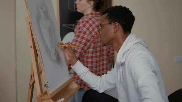 Portrait of Smiling Man Drawing Vase Sketch on White Canvas