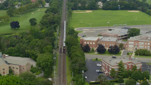 Tilt Up Aerial of Train Passing Through Garden City Long Island