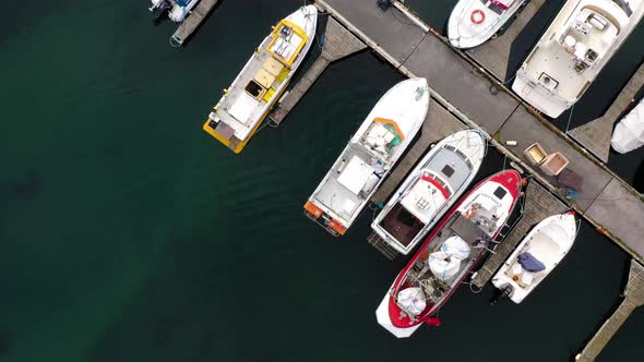 Overhead View Of Fishing Boats And Yachts Moored At Marina. - aerial