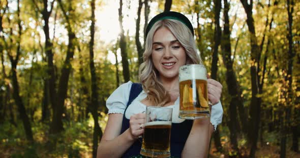 Slavic Woman Clinks Glasses of Beer and Stretches Them To Camera in Forest