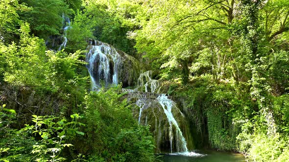 Video with a beautiful waterfall in green spring forest