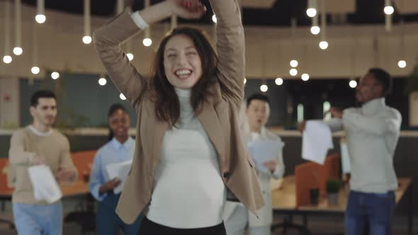 Happy Young Business Woman Dancing in Modern Office and Throws Away Stack of Documents
