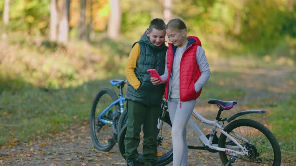 Children Look at the Phone While in Nature