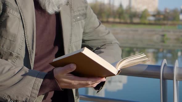 Closeup of Senior Male Caucasian Hands Holding Book