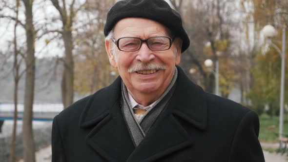 close up portrait of handsome american elderly man looking to camera intense focused