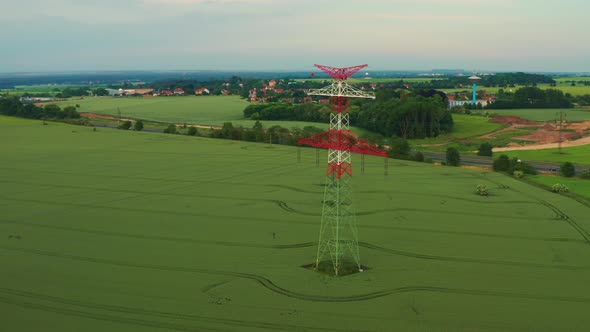 Lacy Tower with Power Transmission Lines in Field Near Road