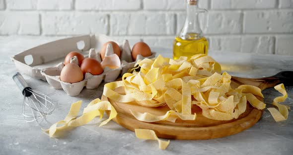 Dry Fettuccine Pasta with Eggs and Oil Slowly Rotates. 